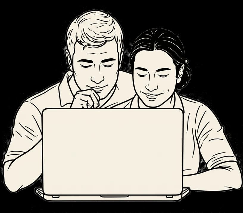 A team lead and a report working together at a laptop